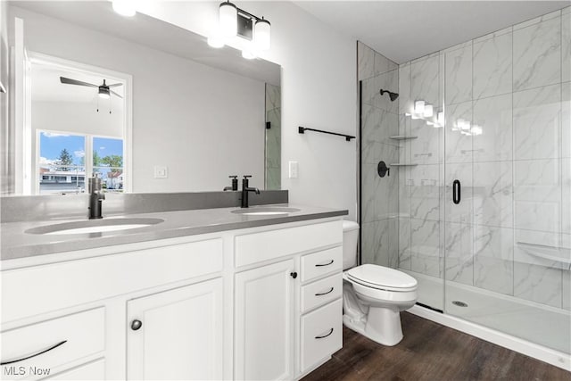 374 Bascule Dr, Lorain, OH 44052 - bathroom featuring a marble finish shower, double vanity, wood finished floors, and ceiling fan