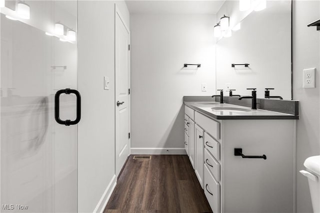 374 Bascule Dr, Lorain, OH 44052 - bathroom featuring wood finished floors, double vanity, and an enclosed shower