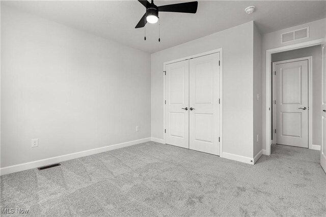 374 Bascule Dr, Lorain, OH 44052 - unfurnished bedroom with carpet, a closet, and ceiling fan