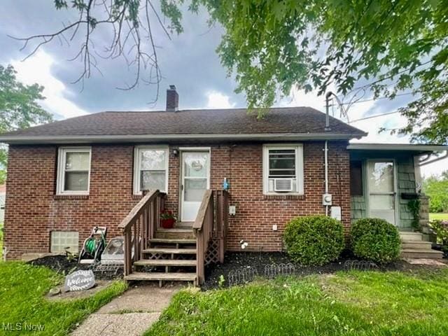 39 Wayne St, Niles, OH 44446 - view of front of home featuring brick siding, a chimney, a front yard, and a shingled roof