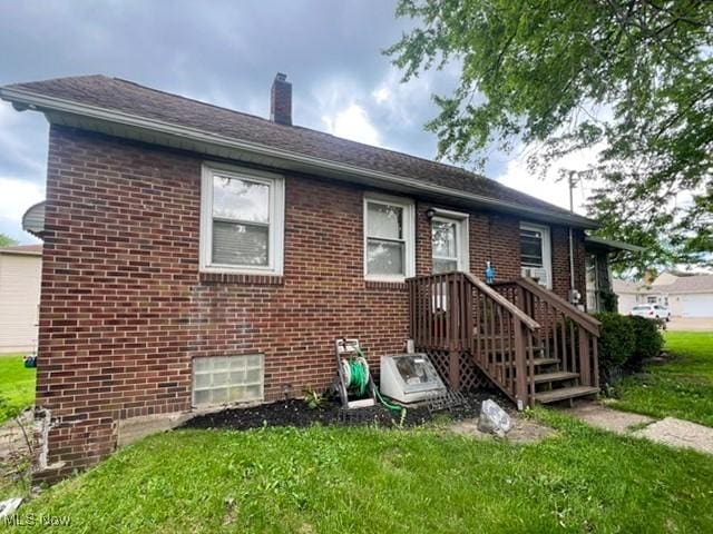 39 Wayne St, Niles, OH 44446 - rear view of property with a lawn, a chimney, and brick siding