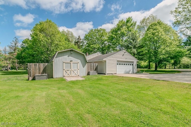 13970 E Willard Rd, Novelty, OH 44072 - view of front of home with concrete driveway, an outdoor structure, an attached garage, and view of wooded area