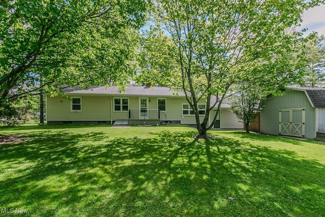 13970 E Willard Rd, Novelty, OH 44072 - back of house featuring a storage unit, an outbuilding, and a yard