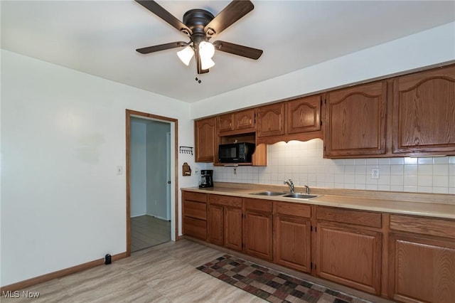 13970 E Willard Rd, Novelty, OH 44072 - kitchen with black microwave, a sink, light countertops, and ceiling fan