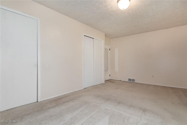 13970 E Willard Rd, Novelty, OH 44072 - unfurnished bedroom with carpet floors, two closets, and a textured ceiling