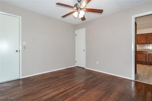 13970 E Willard Rd, Novelty, OH 44072 - empty room with dark wood-style flooring, a ceiling fan, and baseboards