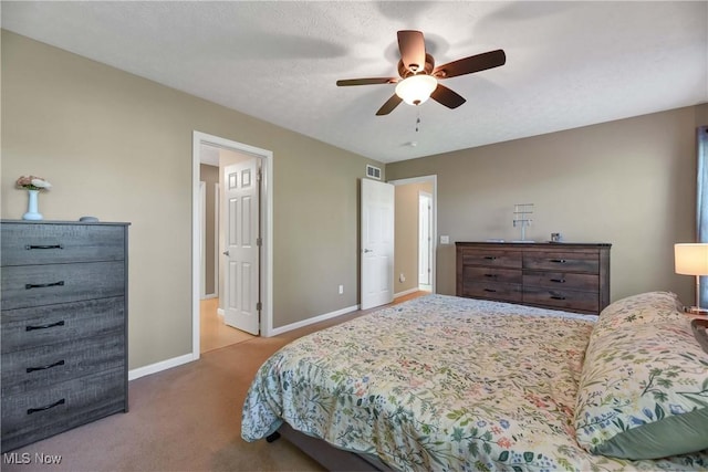 bedroom with baseboards, carpet flooring, and a ceiling fan