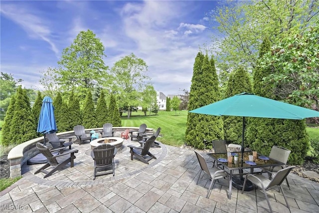 view of patio / terrace with an outdoor fire pit and outdoor dining space
