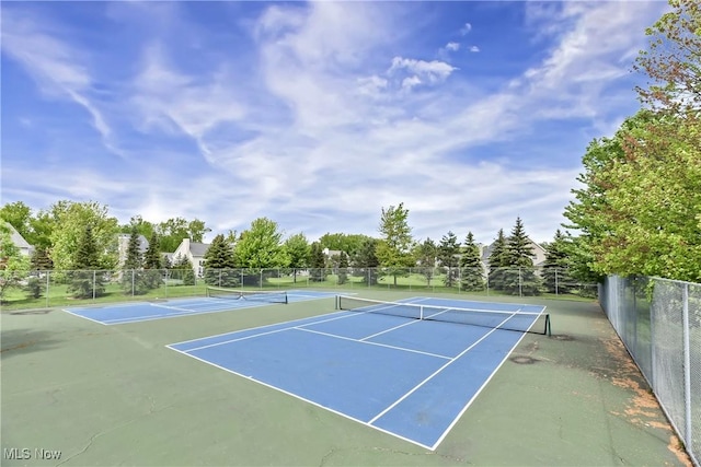 view of tennis court with fence