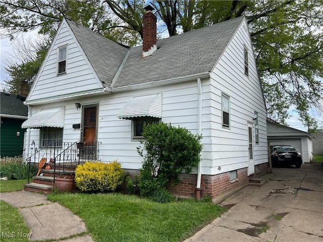 14114 Berwyn Ave, Cleveland, OH 44111 - bungalow-style home with a chimney, roof with shingles, a garage, and an outbuilding