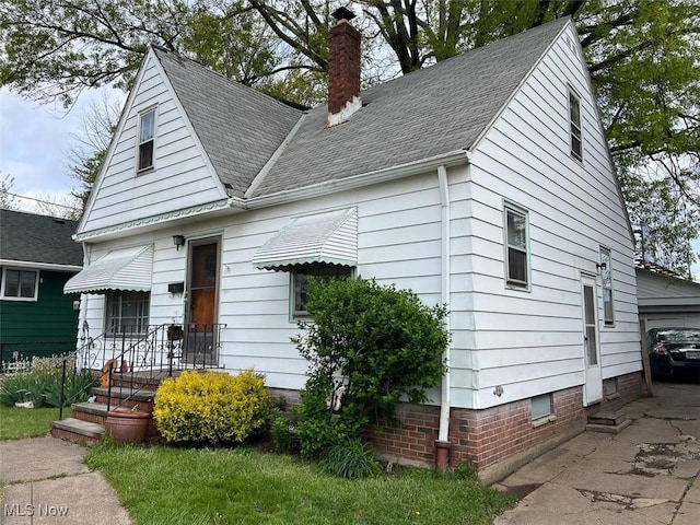 14114 Berwyn Ave, Cleveland, OH 44111 - bungalow-style house with a chimney and roof with shingles