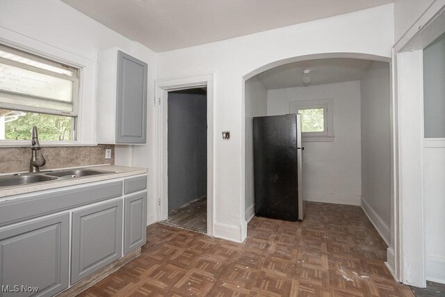 408 Bacon, Akron, OH 44320 - kitchen with freestanding refrigerator, a sink, gray cabinets, arched walkways, and light countertops