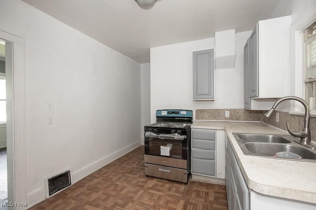 408 Bacon, Akron, OH 44320 - kitchen with stainless steel gas stove, a sink, light countertops, gray cabinets, and baseboards