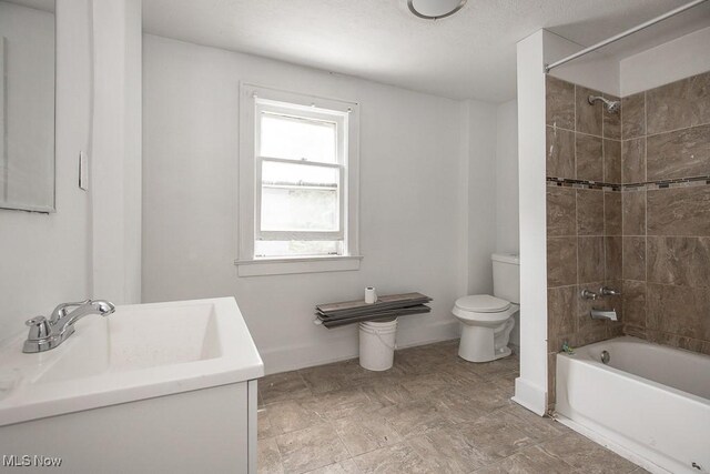 408 Bacon, Akron, OH 44320 - bathroom featuring toilet, shower / bathtub combination, baseboards, and vanity