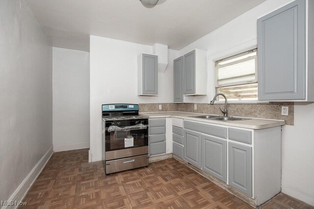 408 Bacon, Akron, OH 44320 - kitchen featuring stainless steel gas range, a sink, light countertops, gray cabinetry, and baseboards