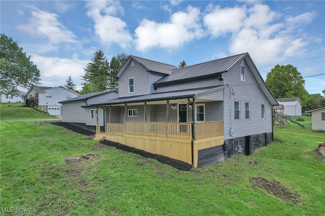 35 W 5th St, Dresden, OH 43821 - rear view of property with a porch, a lawn, and metal roof