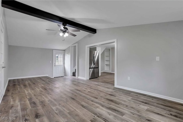 35 W 5th St, Dresden, OH 43821 - empty room with wood finished floors, ceiling fan, baseboards, and stairway