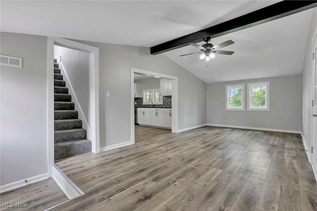 35 W 5th St, Dresden, OH 43821 - unfurnished living room with stairway, wood finished floors, a ceiling fan, and baseboards