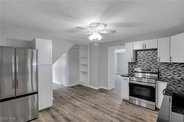35 W 5th St, Dresden, OH 43821 - kitchen with appliances with stainless steel finishes, dark countertops, a ceiling fan, decorative backsplash, and white cabinets