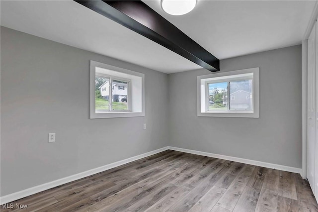 35 W 5th St, Dresden, OH 43821 - empty room featuring baseboards, beam ceiling, and wood finished floors