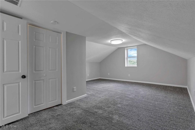 35 W 5th St, Dresden, OH 43821 - bonus room featuring baseboards, carpet flooring, lofted ceiling, and a textured ceiling