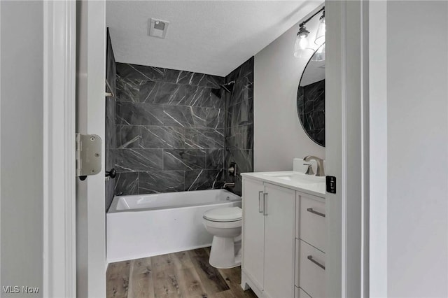 35 W 5th St, Dresden, OH 43821 - bathroom with toilet, wood finished floors, shower / tub combination, vanity, and a textured ceiling