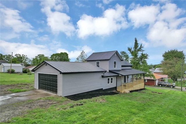 35 W 5th St, Dresden, OH 43821 - rear view of property with metal roof, a lawn, and driveway