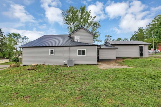 35 W 5th St, Dresden, OH 43821 - back of house with cooling unit, metal roof, a yard, and a patio