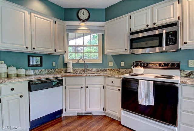 401 Bounty Way, Avon Lake, OH 44012 - kitchen featuring stainless steel microwave, electric range, white dishwasher, a sink, and white cabinetry