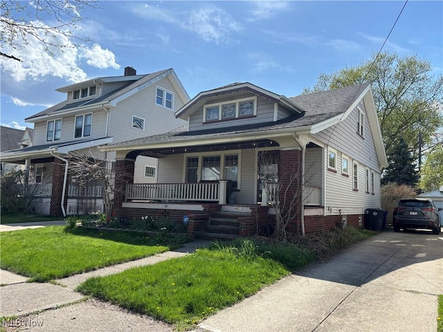 4212 W 48th St, Cleveland, OH 44144 - bungalow-style home with covered porch and a front yard