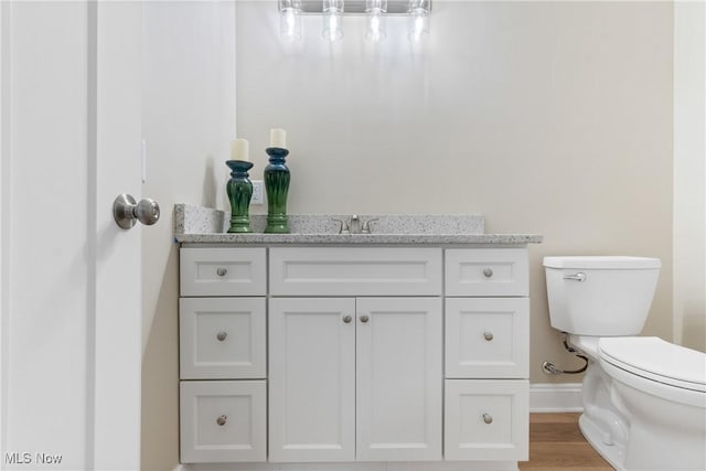 26 Oneida Trl, Malvern, OH 44644 - bathroom featuring toilet, baseboards, vanity, and wood finished floors
