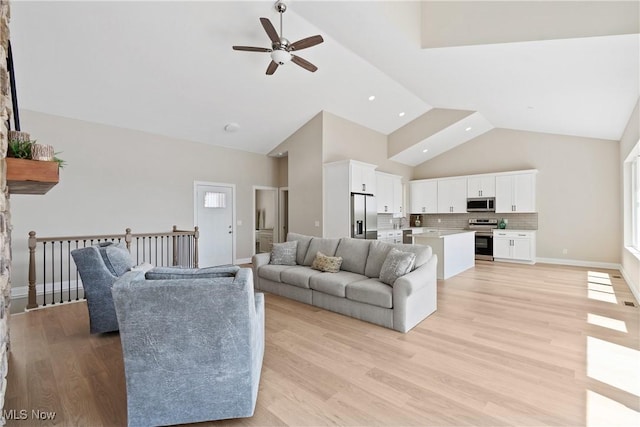 26 Oneida Trl, Malvern, OH 44644 - living room featuring high vaulted ceiling, ceiling fan, light wood finished floors, baseboards, and recessed lighting