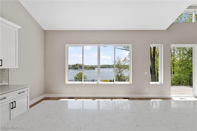 26 Oneida Trl, Malvern, OH 44644 - empty room featuring baseboards, wood finished floors, and a water view