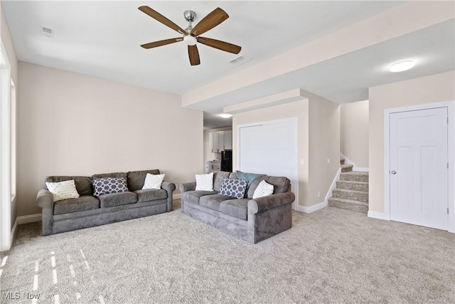 26 Oneida Trl, Malvern, OH 44644 - carpeted living area with ceiling fan, stairs, and baseboards