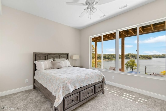 26 Oneida Trl, Malvern, OH 44644 - bedroom featuring baseboards, light colored carpet, and a water view