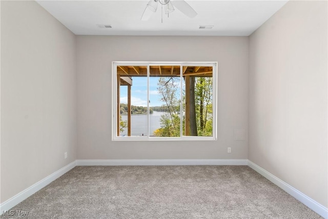 26 Oneida Trl, Malvern, OH 44644 - carpeted spare room with baseboards, a ceiling fan, and a water view