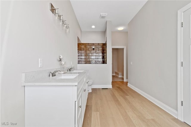 26 Oneida Trl, Malvern, OH 44644 - full bathroom with wood finished floors, baseboards, double vanity, and toilet