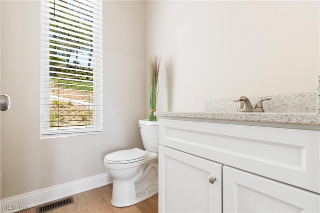 26 Oneida Trl, Malvern, OH 44644 - half bath featuring vanity, baseboards, toilet, and wood finished floors