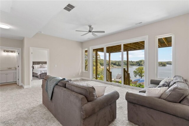 26 Oneida Trl, Malvern, OH 44644 - living room with a ceiling fan, light colored carpet, baseboards, and a water view