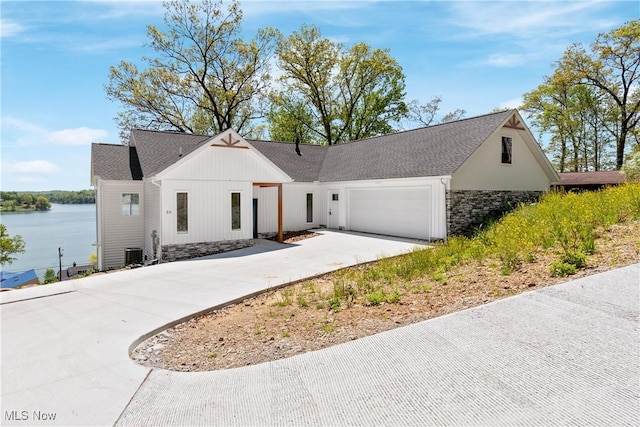 26 Oneida Trl, Malvern, OH 44644 - modern farmhouse with stone siding, a garage, driveway, and a shingled roof
