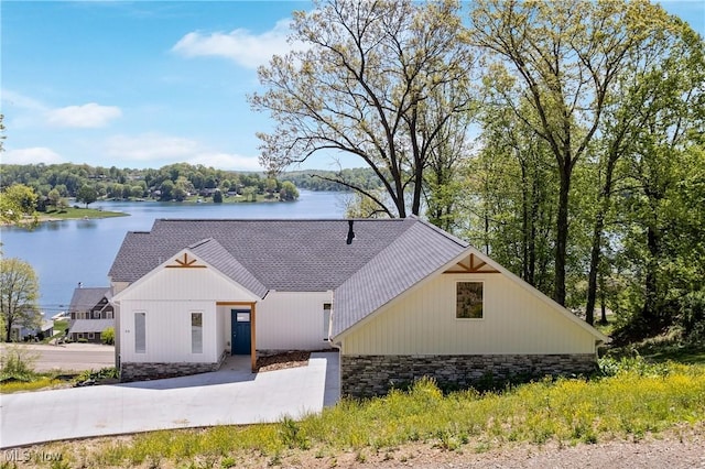 26 Oneida Trl, Malvern, OH 44644 - modern farmhouse with stone siding, a water view, and roof with shingles