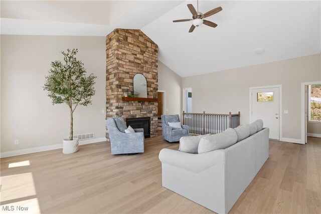 26 Oneida Trl, Malvern, OH 44644 - living room with ceiling fan, light wood-style flooring, a fireplace, high vaulted ceiling, and baseboards