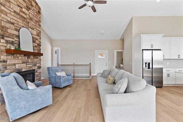 26 Oneida Trl, Malvern, OH 44644 - living area featuring ceiling fan, light wood-style flooring, high vaulted ceiling, and a fireplace