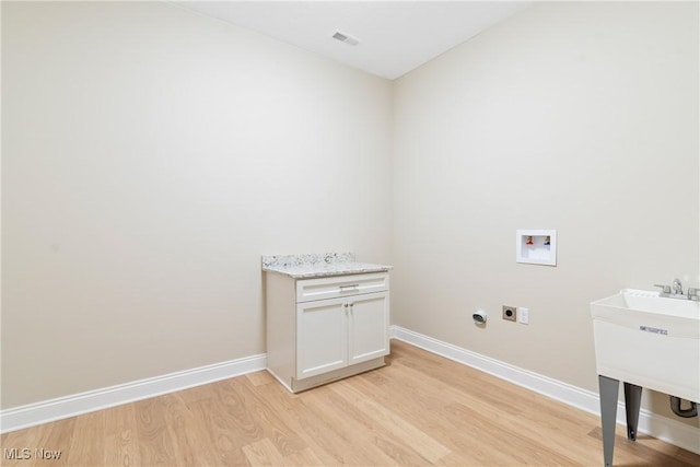 26 Oneida Trl, Malvern, OH 44644 - laundry area featuring washer hookup, hookup for an electric dryer, light wood-type flooring, baseboards, and a sink