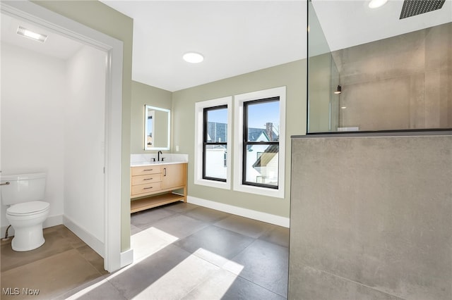 full bathroom with baseboards, a walk in shower, toilet, vanity, and concrete floors
