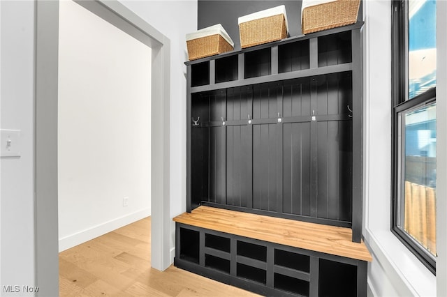 mudroom featuring wood finished floors and baseboards