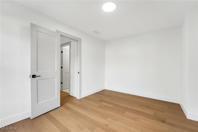 spare room with light wood-style flooring and baseboards