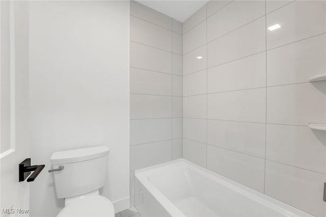 bathroom with toilet and baseboards