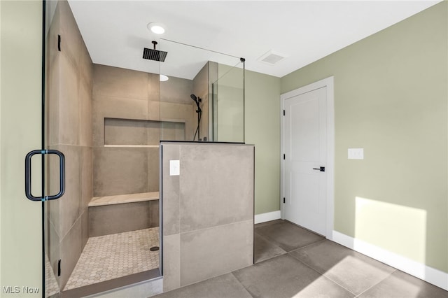 bathroom with baseboards and a stall shower
