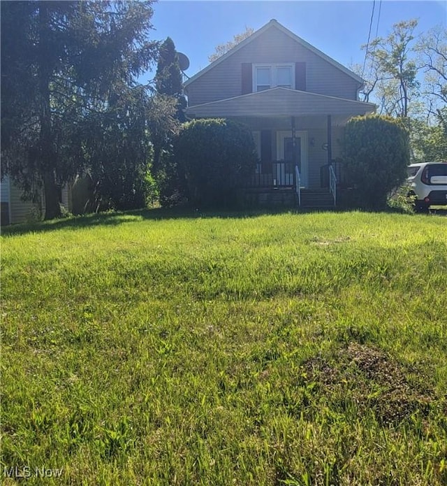 9788 E River Rd, Elyria, OH 44035 - view of front of property featuring covered porch and a front lawn